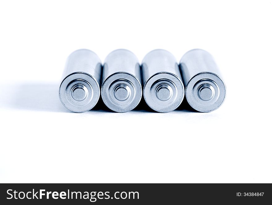 Few ordinary batteries in a row on white background. Few ordinary batteries in a row on white background