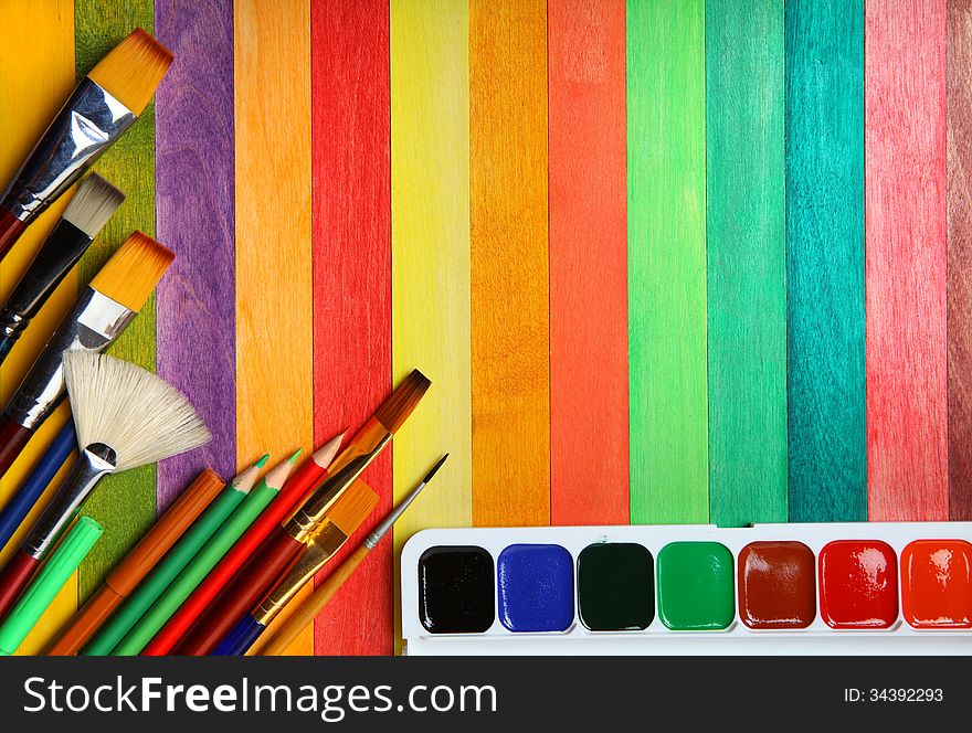 Watercolor paints with brushes and colorful pencils. Watercolor paints with brushes and colorful pencils