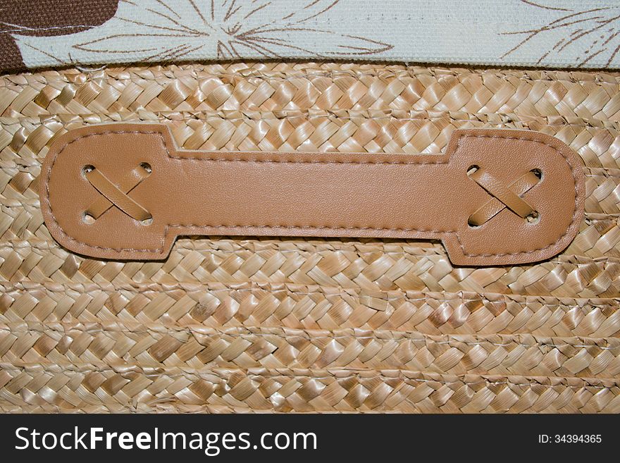 Closeup of a basket weave texture, leather handle, fabric