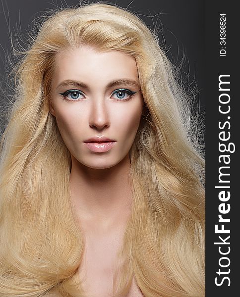 Pure Beauty. Portrait Of Young Blonde With Healthy Flowing Hair