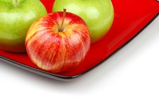 Three Apples On Red Plate Stock Photo