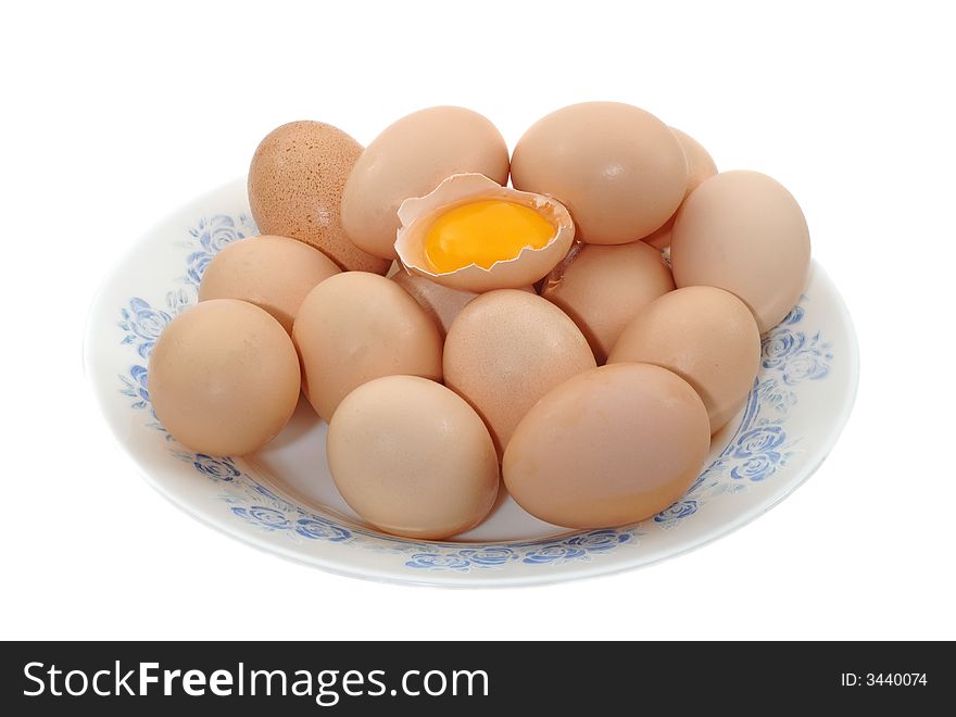 Eggs in the plate on white, one is broken. Eggs in the plate on white, one is broken
