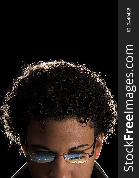 Backlit portrait of young man with abstract reflection in glasses. Backlit portrait of young man with abstract reflection in glasses