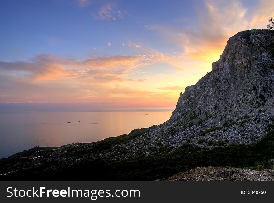 Black sea Crimea Laspi sunset water sky clouds tree mountain bay gulf. Black sea Crimea Laspi sunset water sky clouds tree mountain bay gulf