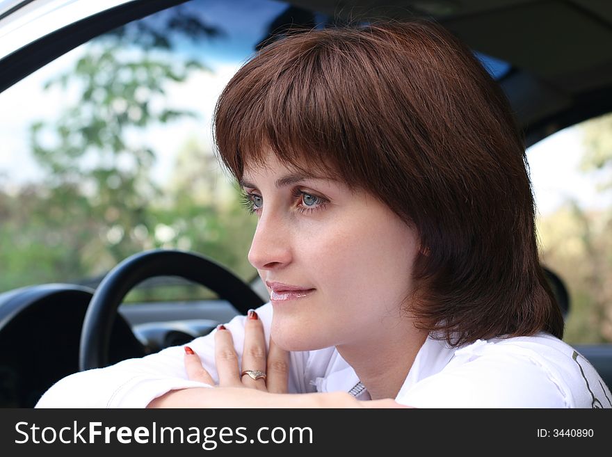Portrait of the girl sitting in automobile