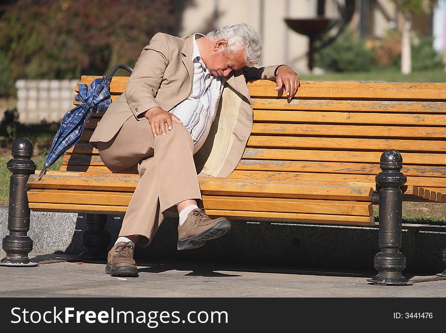 A man sitting on a park bench. A man sitting on a park bench