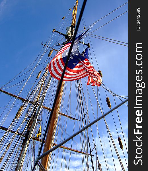Looking up at an American flag on a ship's mast. Looking up at an American flag on a ship's mast