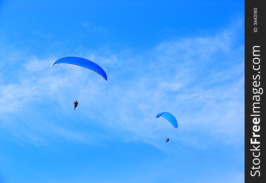 Parachute Flying In The Blue Sky