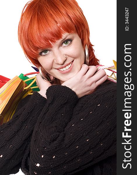 Redhead smiling beautiful girl with shoppingbags over white. Redhead smiling beautiful girl with shoppingbags over white