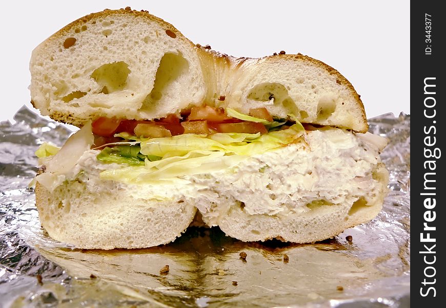 A cross section view of a chicken salad on bagel sandwich. A cross section view of a chicken salad on bagel sandwich