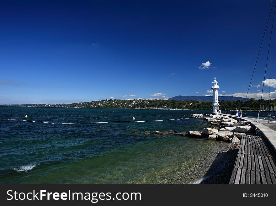 The lighthouse on Leman lake in Geneva and the blue water and sky forms a beautiful picture.