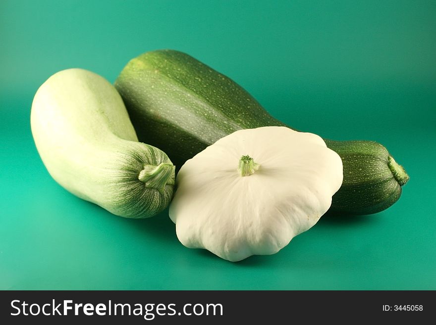 Two  marrows and bush pumpkin on a green background.