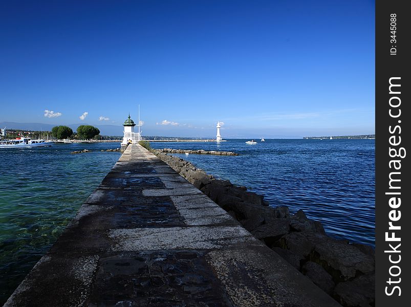 The way leading to the lighthouse in Leman Lake, and the far end senery, forms a peaceful picture. The way leading to the lighthouse in Leman Lake, and the far end senery, forms a peaceful picture.