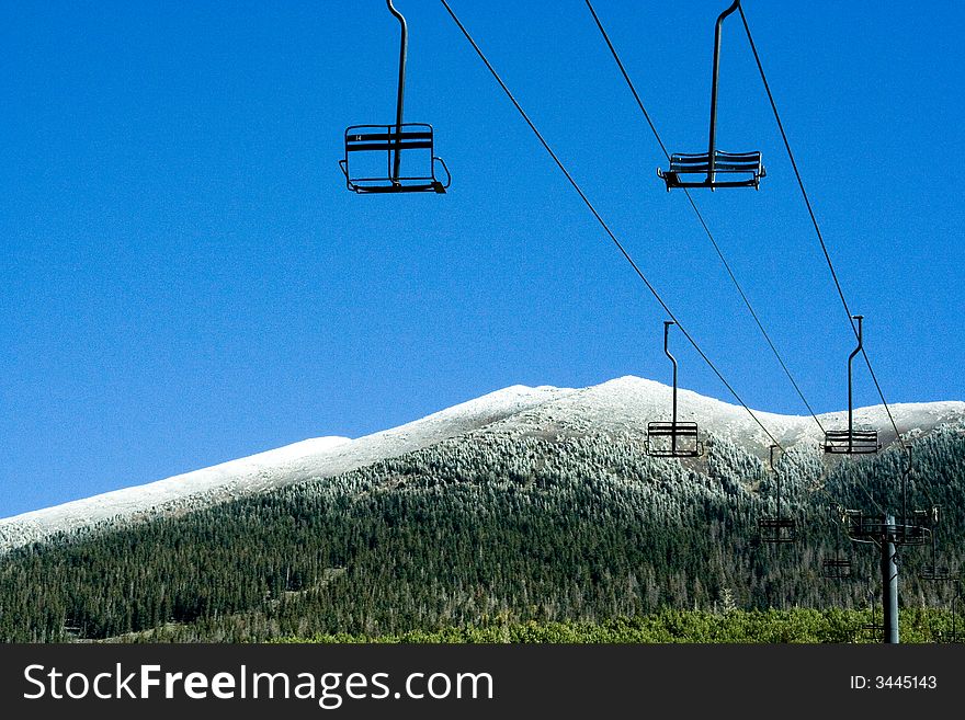 Ski lifts at ski resort with mountain snow.