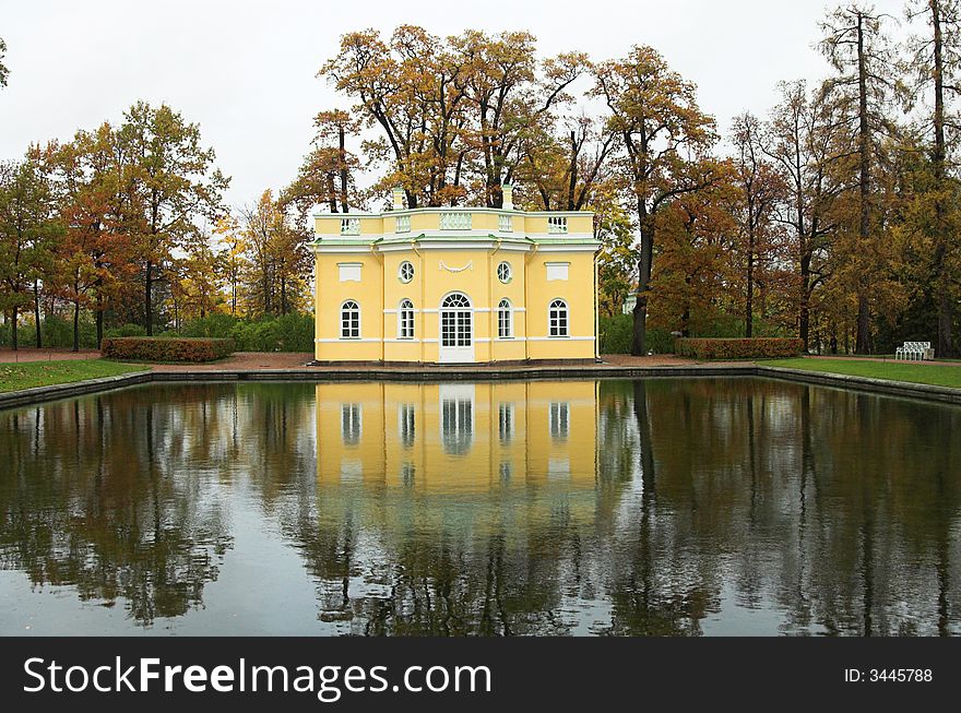 Yellow pavilion reflected in water in park St Petersburg. Yellow pavilion reflected in water in park St Petersburg