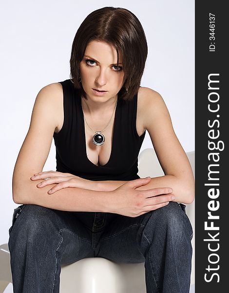 A portrait of a beautiful woman wearing jeans and black shirt on white background. A portrait of a beautiful woman wearing jeans and black shirt on white background