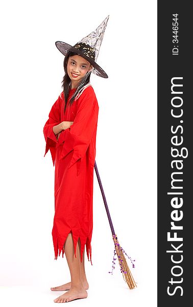 A young girl dressed in a witch costume