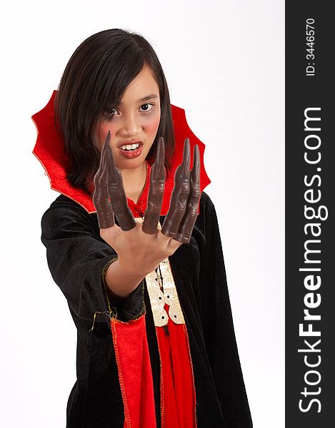 A young girl dressed in a halloween costume over a white background. A young girl dressed in a halloween costume over a white background