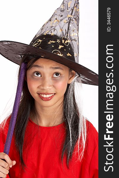 A young girl dressed in a witch costume