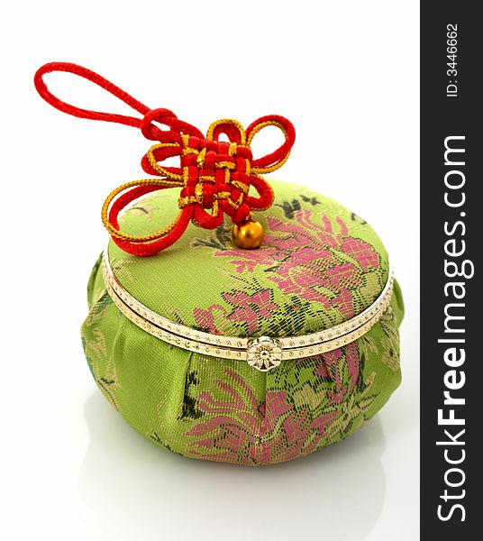 A green chinese jewelry container over a white background