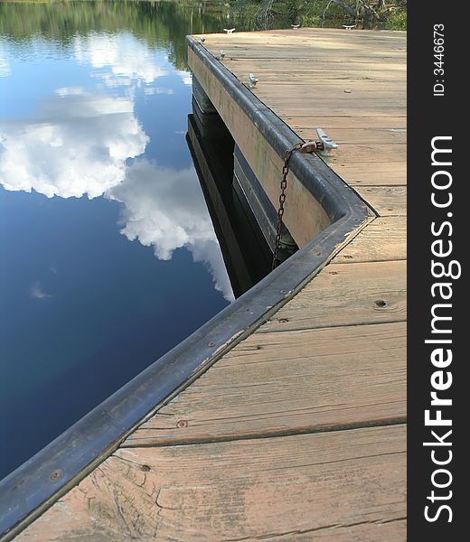 Reflective Clouds on lake with dock. Reflective Clouds on lake with dock