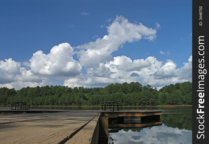 Reflective Clouds on lake with dock. Reflective Clouds on lake with dock