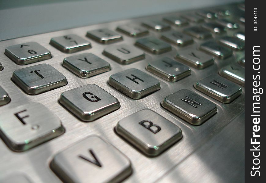A keyboard made of brushed steel with black key text.