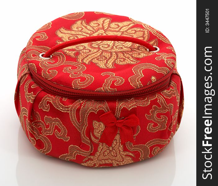 A red chinese jewelry container over a white background