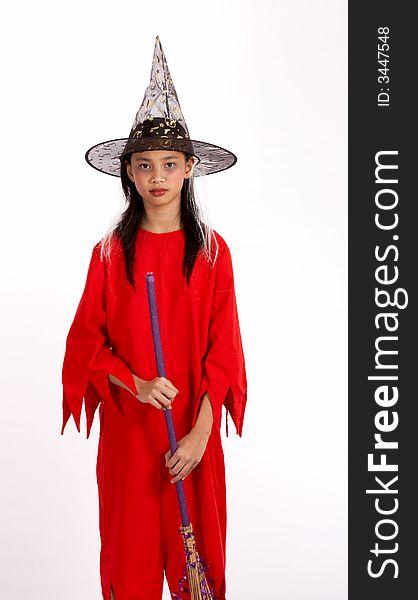A young girl dressed in a witch costume