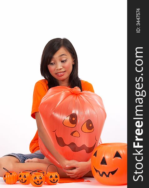 A young girl and some pumpkins over a white background. A young girl and some pumpkins over a white background