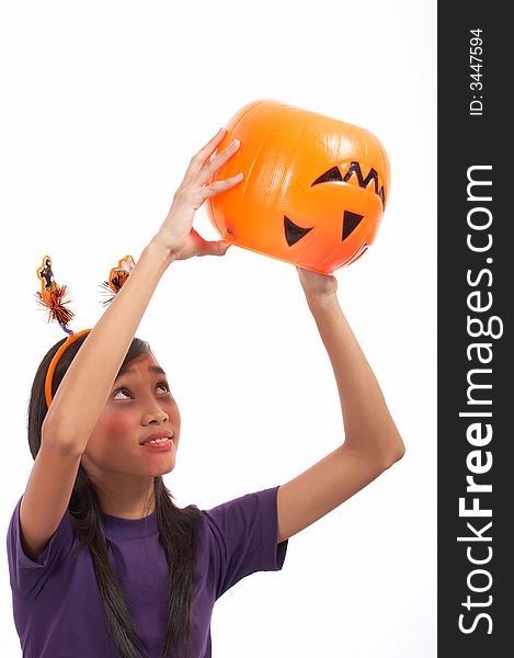 A girl looking at her empty pumpkin over a white background