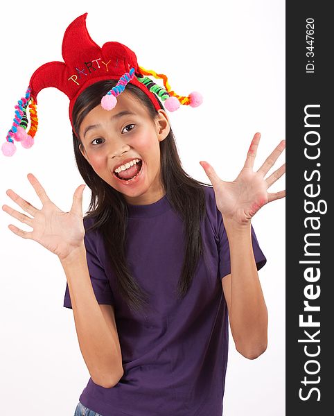 A young girl wearing a funny headband over a white background. A young girl wearing a funny headband over a white background