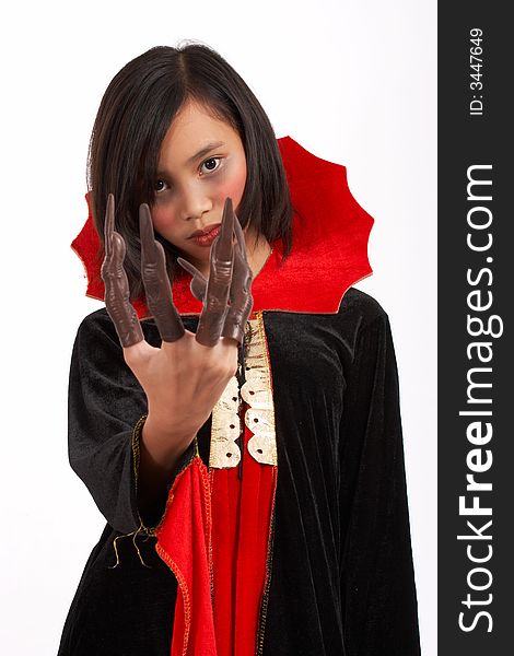 A young girl dressed in a Halloween costume over a white background. A young girl dressed in a Halloween costume over a white background