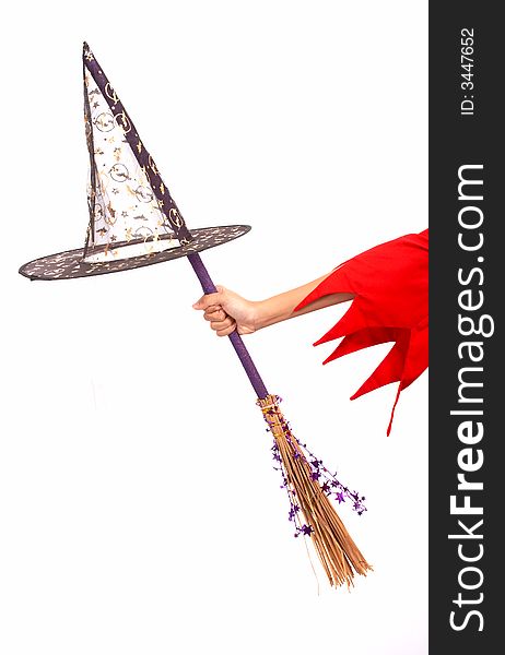 A witch hat and a broomstick over a white background