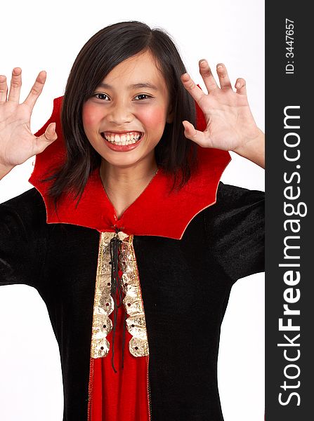 A young girl dressed in a halloween costume over a white background. A young girl dressed in a halloween costume over a white background