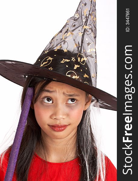 A young girl dressed in a witch costume