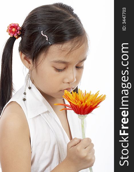 A young girl holding a flower over a white background. A young girl holding a flower over a white background