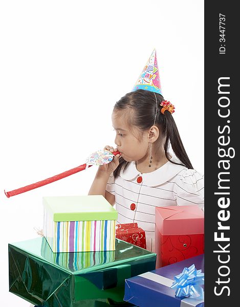 A girl wearing a party hat over a white background. A girl wearing a party hat over a white background