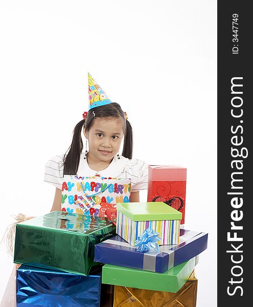 A girl wearing a party hat over a white background. A girl wearing a party hat over a white background