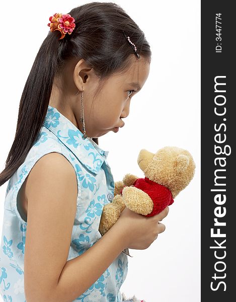 A girl with a teddy bear over a white background