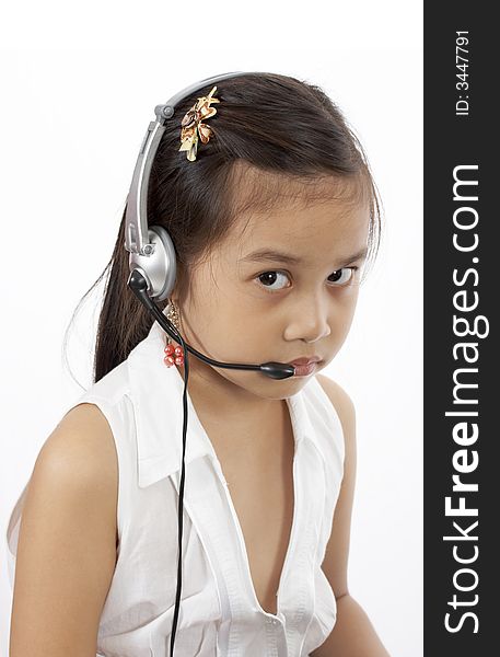 A girl wearing a headset over a white background. A girl wearing a headset over a white background