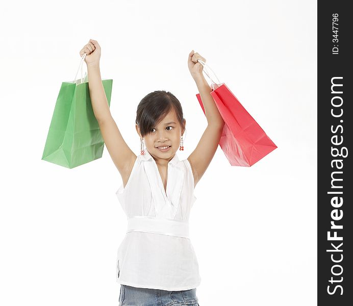 A young girl carrying a shopping bag