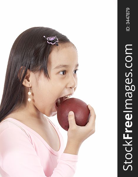 A girl biting an apple
