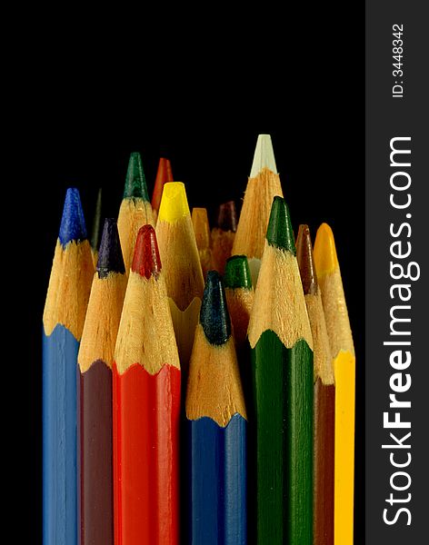 Color pencils, black background, isolated,