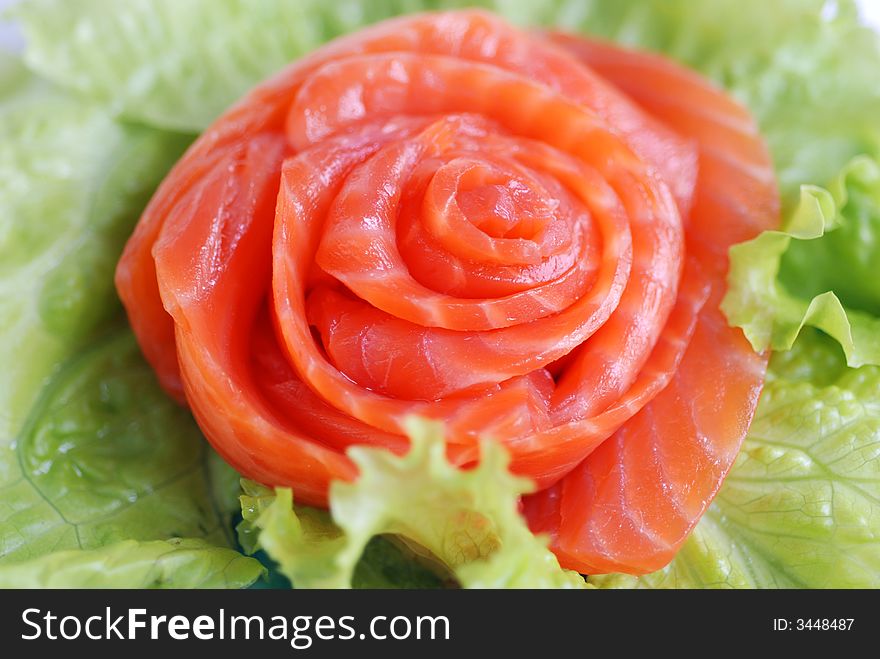 Delicious red fish and leafs close up