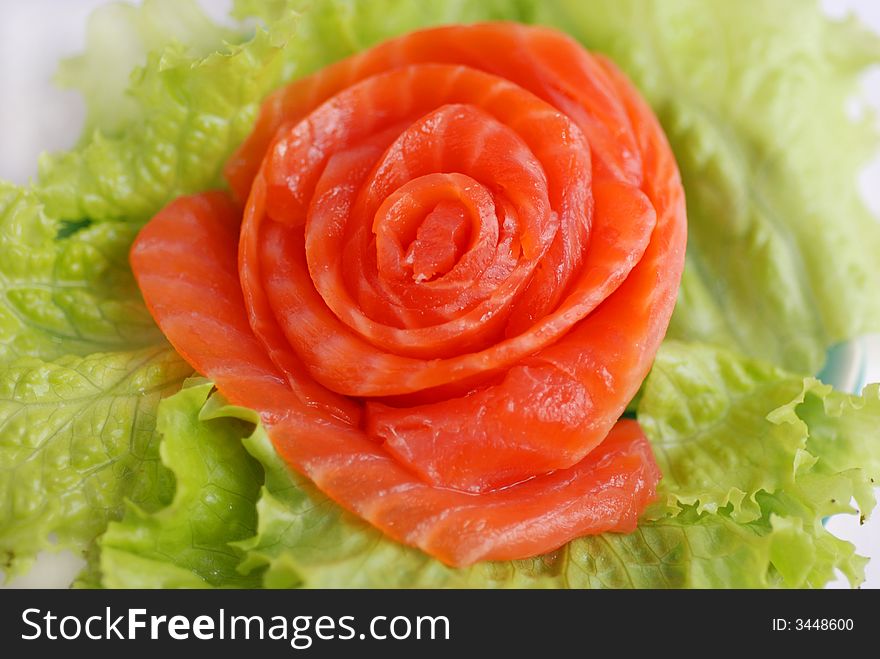 Delicious red fish and leafs close up