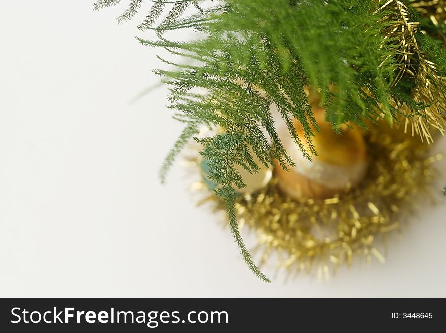 Green branch and a golden christmas glass decoration ball. Green branch and a golden christmas glass decoration ball.