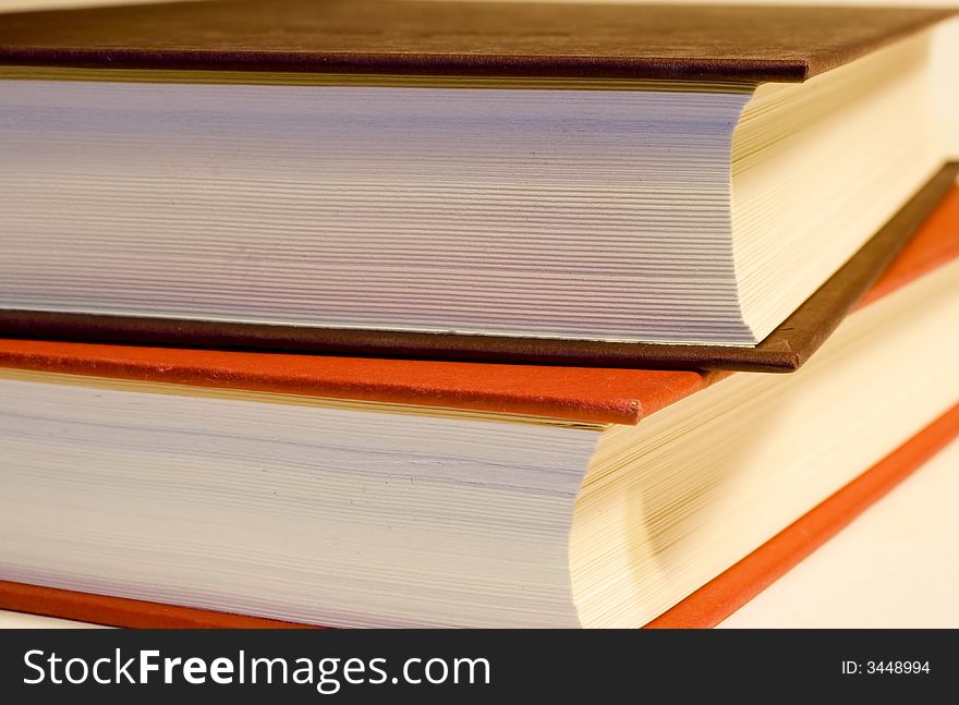 Two hardcover books stacks on a white background. Two hardcover books stacks on a white background.