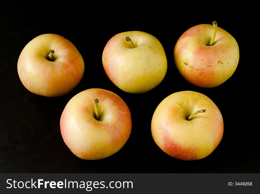 Yellow apples over black background. Yellow apples over black background