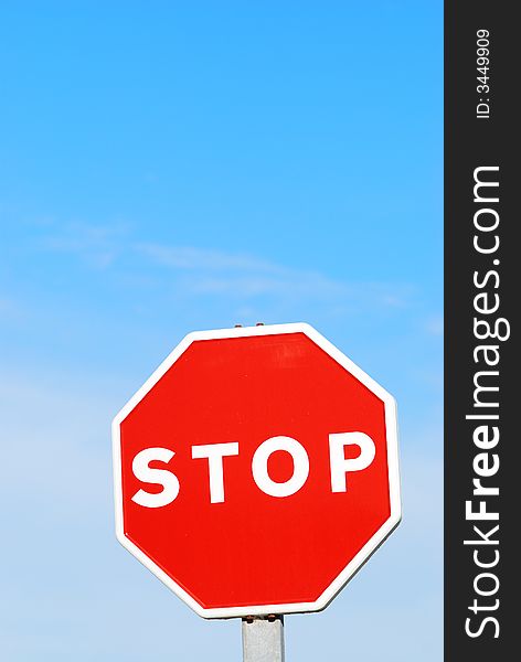 Stop sign against blue sky